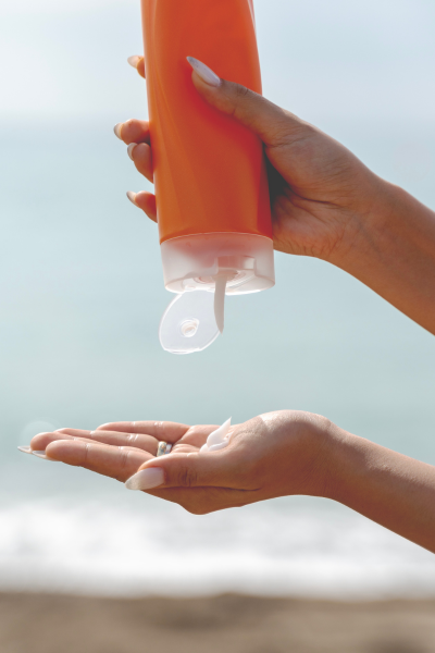 woman with sunscreen bottle - buying sunscreen in bulk